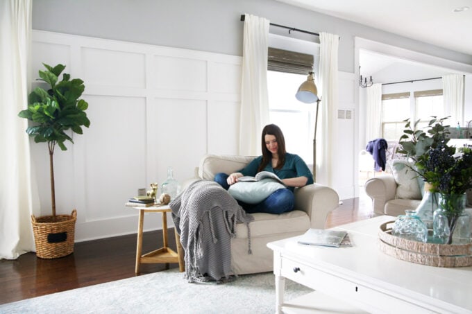 Reading in a cozy chair in an organized living room