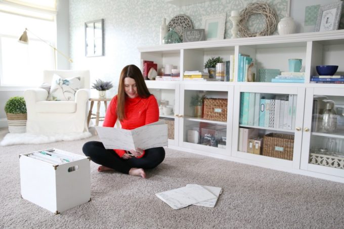 Woman looking at a folder of paperwork in an organized office