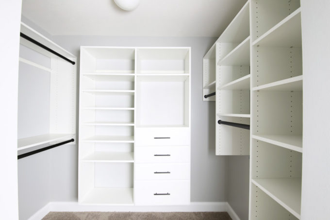 Organized closet system installed in a primary closet, empty