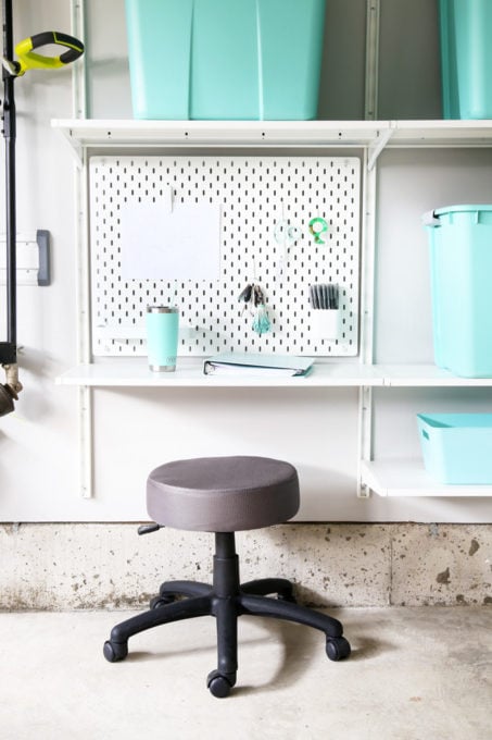 Workstation in an Organized Garage Using IKEA SKADIS Pegboard and IKEA ALGOT Shelving