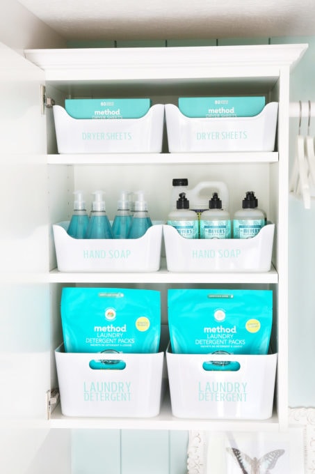 Organized Laundry Room Cabinet with Laundry Detergent, Hand Soap, and Dryer Sheets in Labeled Bins