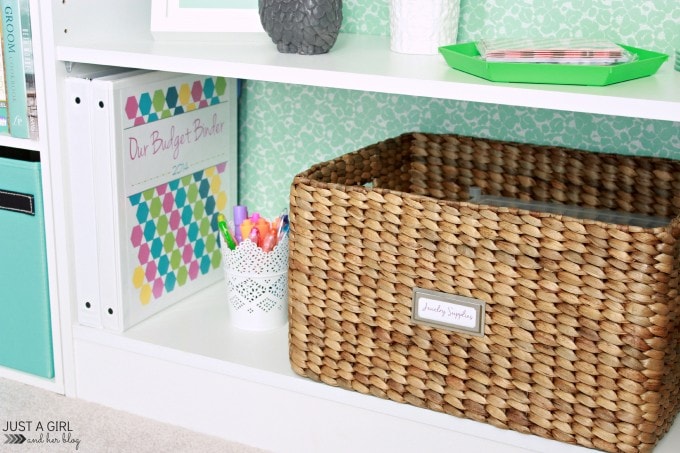 a basket on the shelf next to binders