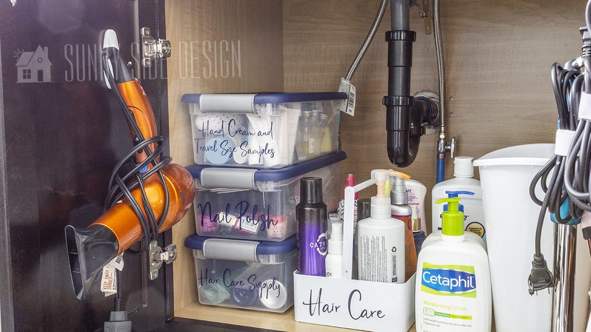 Labeled bins under the organized bathroom sink from Sunny Side Design