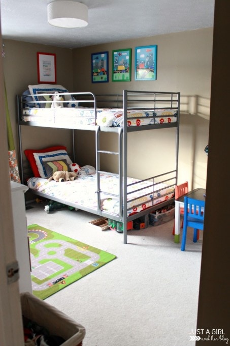 a clean kids' room with made up bunk beds