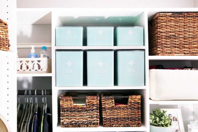 organized medications and first aid supplies in aqua storage bins