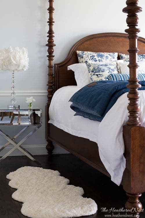 Blue, white, and gray bedroom with wood bed and nightstand