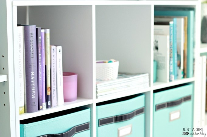 side view of books and bins lined up on the shelf