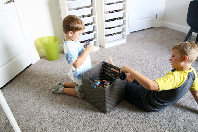 Boys decluttering a toy bin