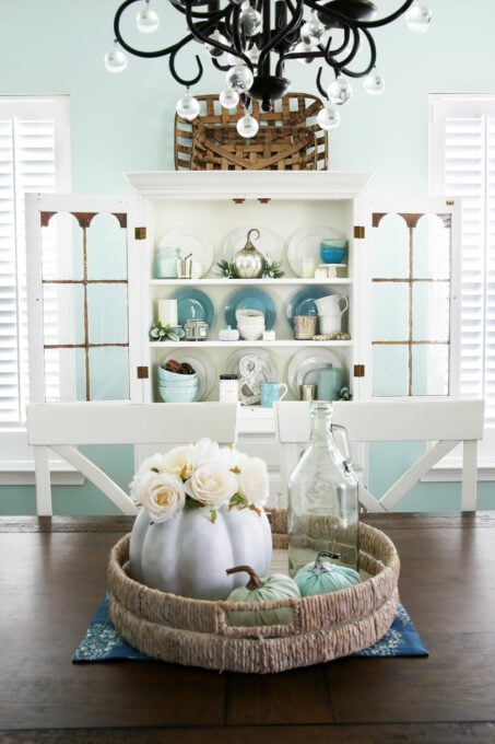 White dining room hutch decorated for fall with aqua, white, and neutral decor