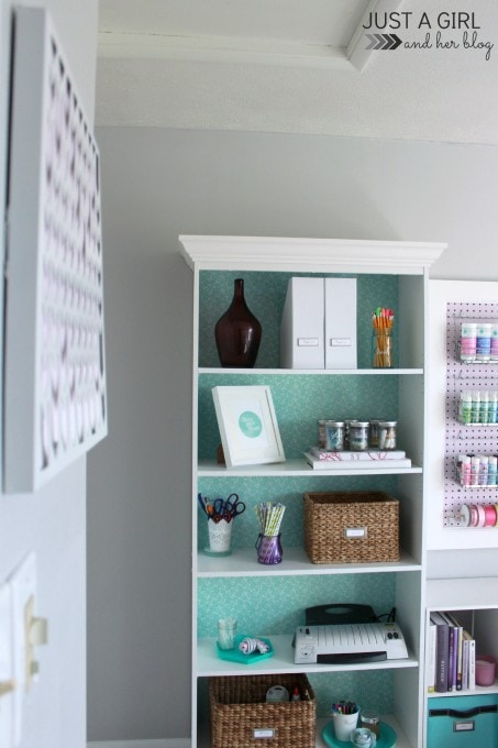 the new office storage system with supplies and decorative items on the shelves