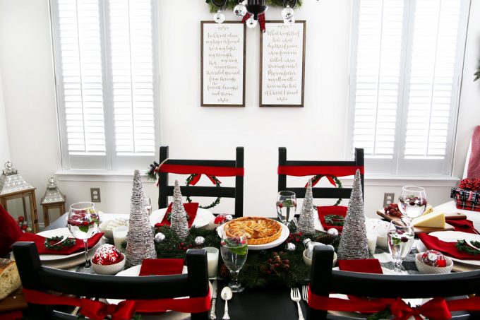 dining room table decorated for Christmas with plantation wood shutters covering the windows