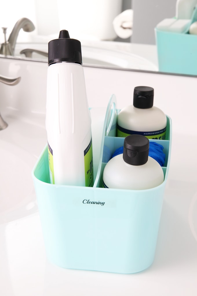 mint cleaning caddy with cleaning supplies