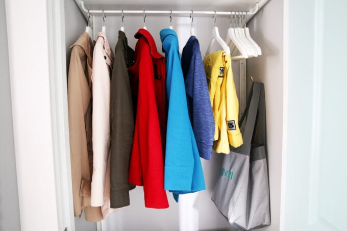 Coats hanging in an organized entryway closet