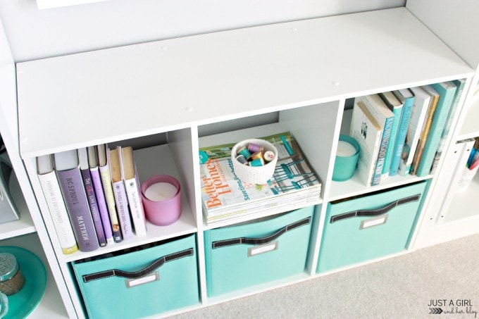 blue bins and books on a shelf