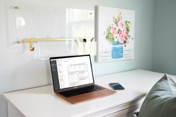 A computer sitting on a white desk in a home office