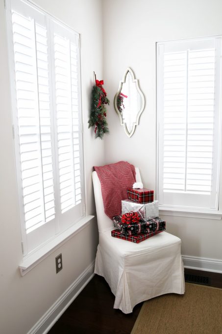 showing the corner of the room with 2 plantation shutters covering the windows