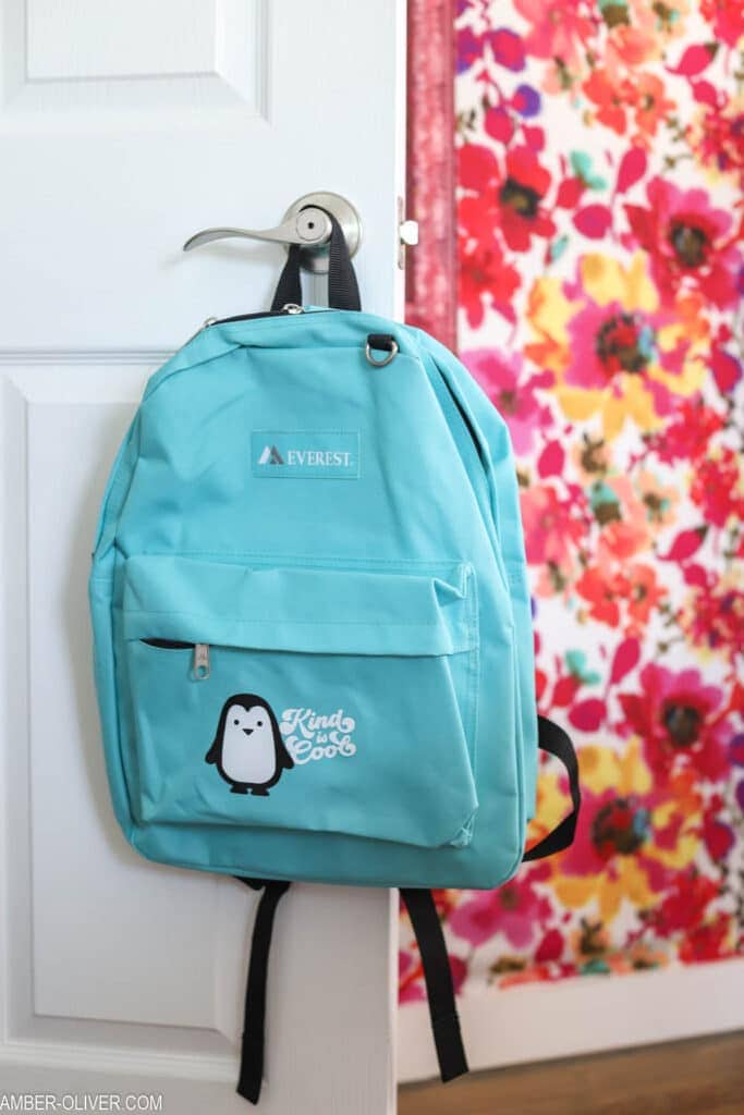 Aqua backpack with a small penguin on front