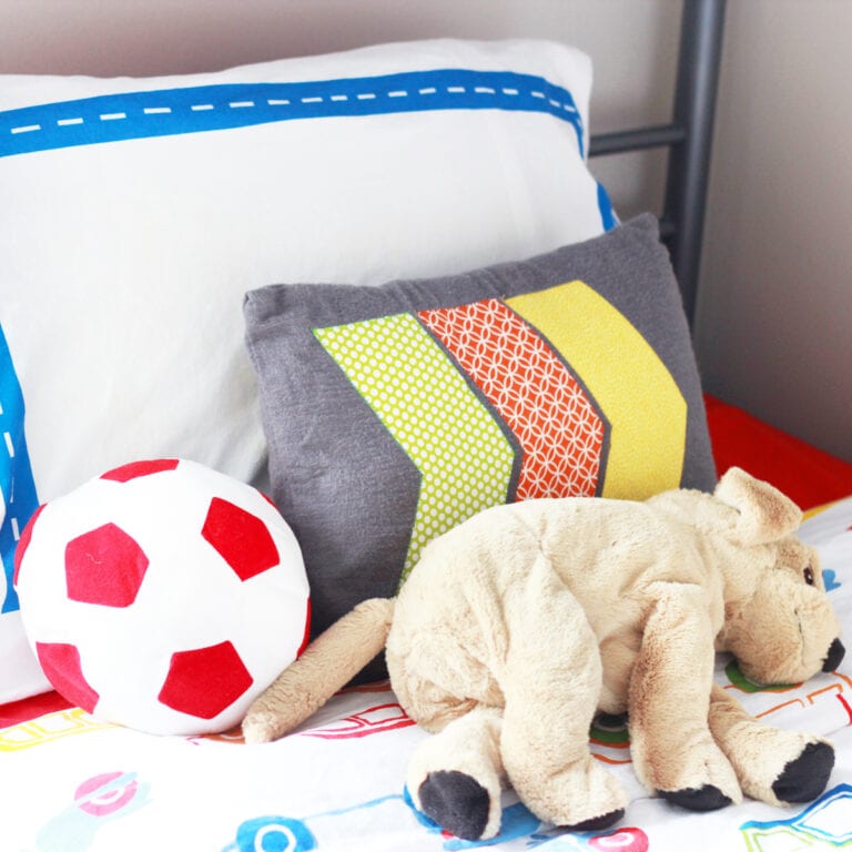 Pillows and Stuffed Toys Laying on a Kid's Bed