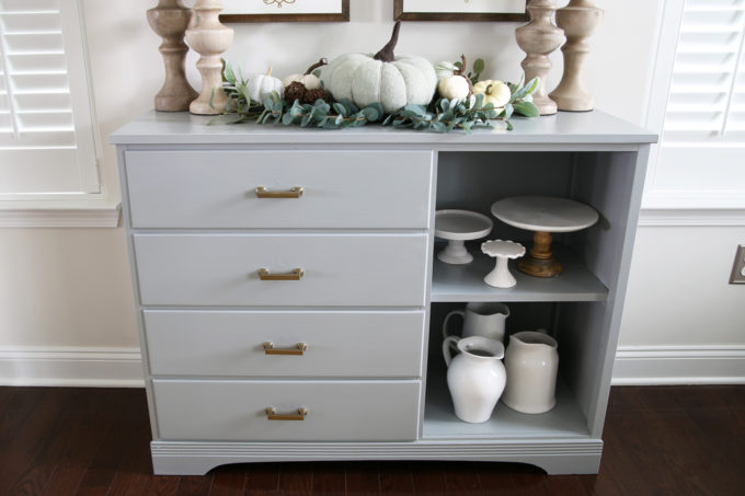 the dresser once we turned it into a sideboard styled with fall items and storing display pieces