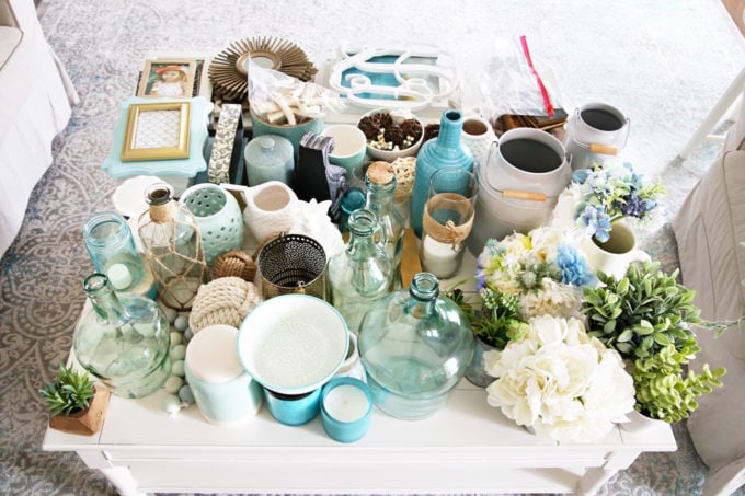 Coffee Table Holding Tons of Decor in an Aqua, White, and Neutral Color Scheme