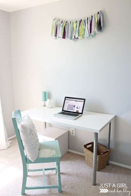 a desk with a computer and chair