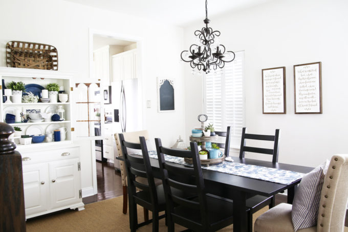 a styled dining room with an empty space on one wall