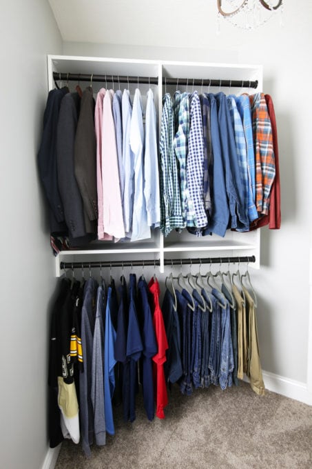 Men's clothing organized into zones in an organized primary closet