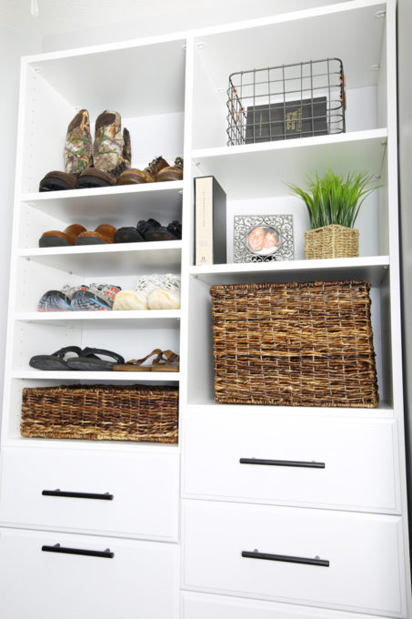 Men's shoes organized by type in an organized closet