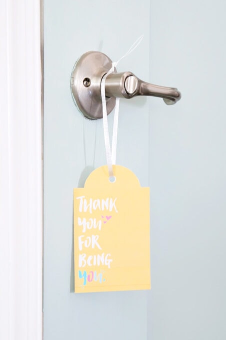 Encouragement gift tag hanging on a door