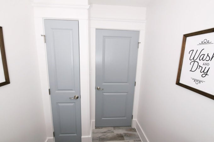 Doors to Linen Closet and Hallway in Small Organized Laundry Room