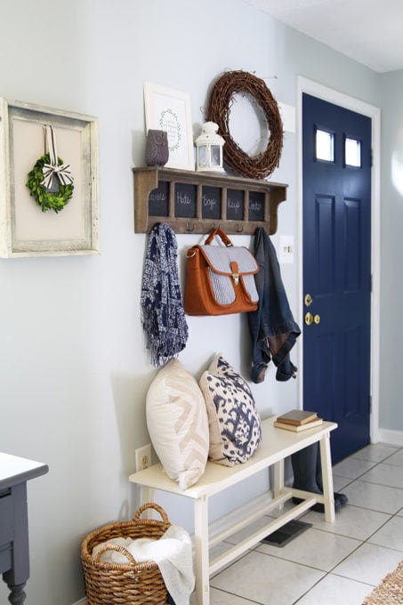 Small Entryway in a Townhouse with a Bench and Hooks for Coats