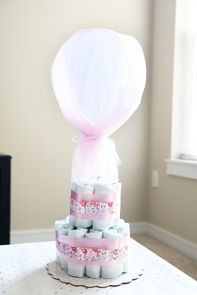 These beautiful diaper cakes make the perfect baby shower centerpieces! They are easy party decor and can be adapted for boys or girls! I'm definitely making these cute decorations for our next shower!