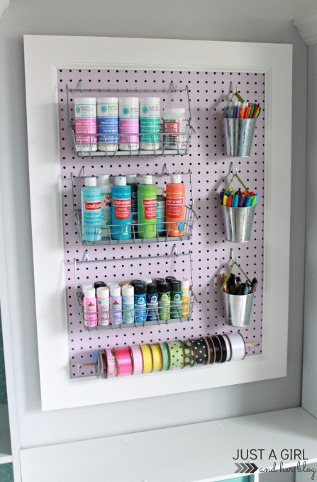 lavender pegboard holding organized craft supplies in a home office