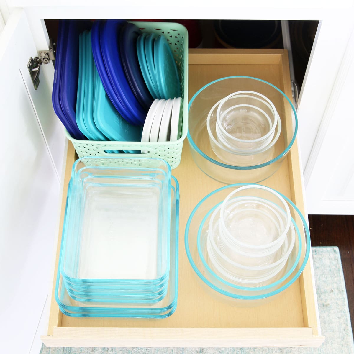 Organized Tupperware Containers in a Kitchen Cabinet