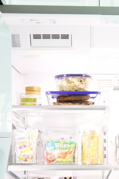 front view of storage containers filled with leftovers in the refrigerator