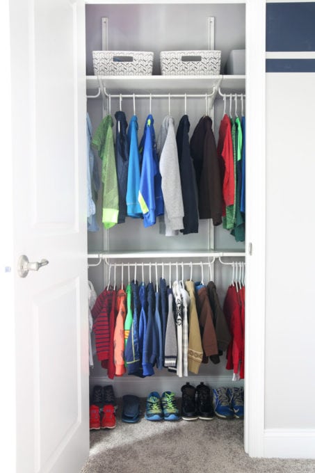 Kids' shared closet with two rows of hanging clothes, closet organization ideas