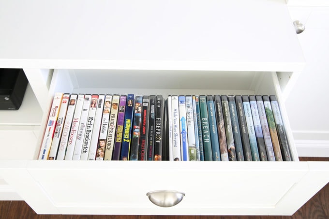 Organized DVDs in Clear Acrylic Bins in the Drawer of an Entertainment Center