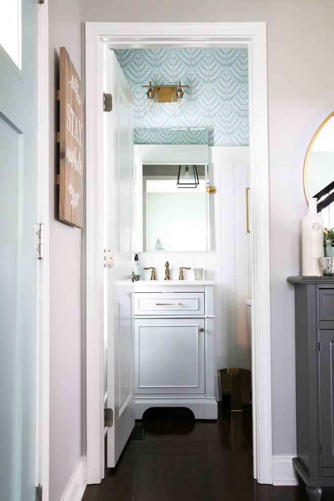 Powder Room with Gray Vanity, Beadboard, and Aqua Wallpaper