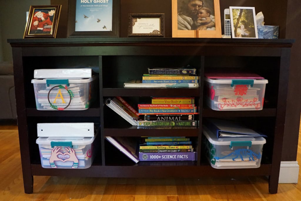 Black cabinets with books and homeschooling bins