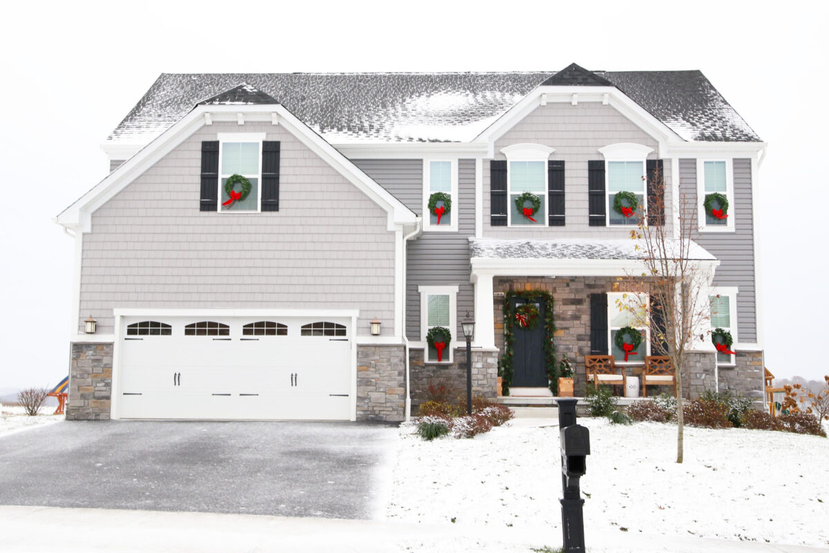 Craftsman Style House Decorated for Christmas with Wreaths on the Windows