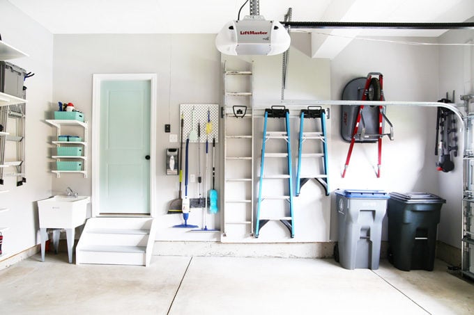 Organized Mops, Brooms, and Ladders in an Organized Garage