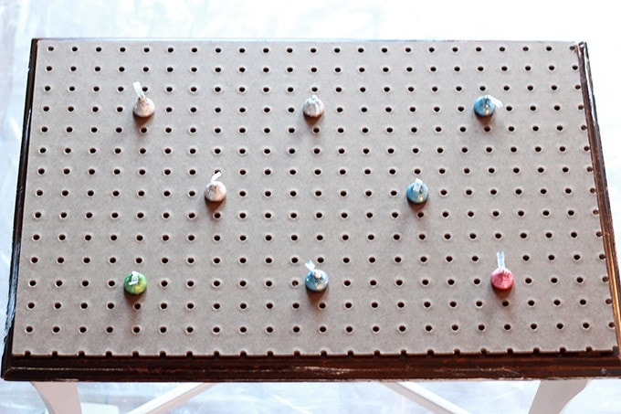 a pegboard on top of the bench with markers to see where the tufts will be