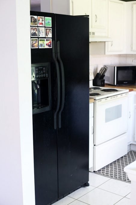 large double door black refrigerator in a white kitchen