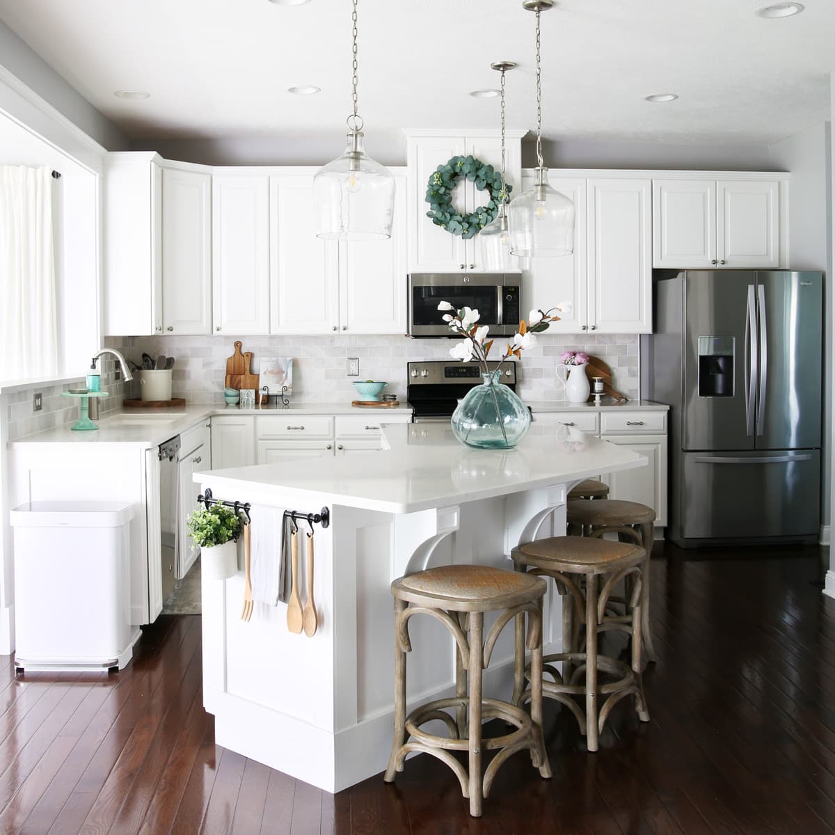 Organized kitchen with white cabinets, a large island, and many smart organizing ideas