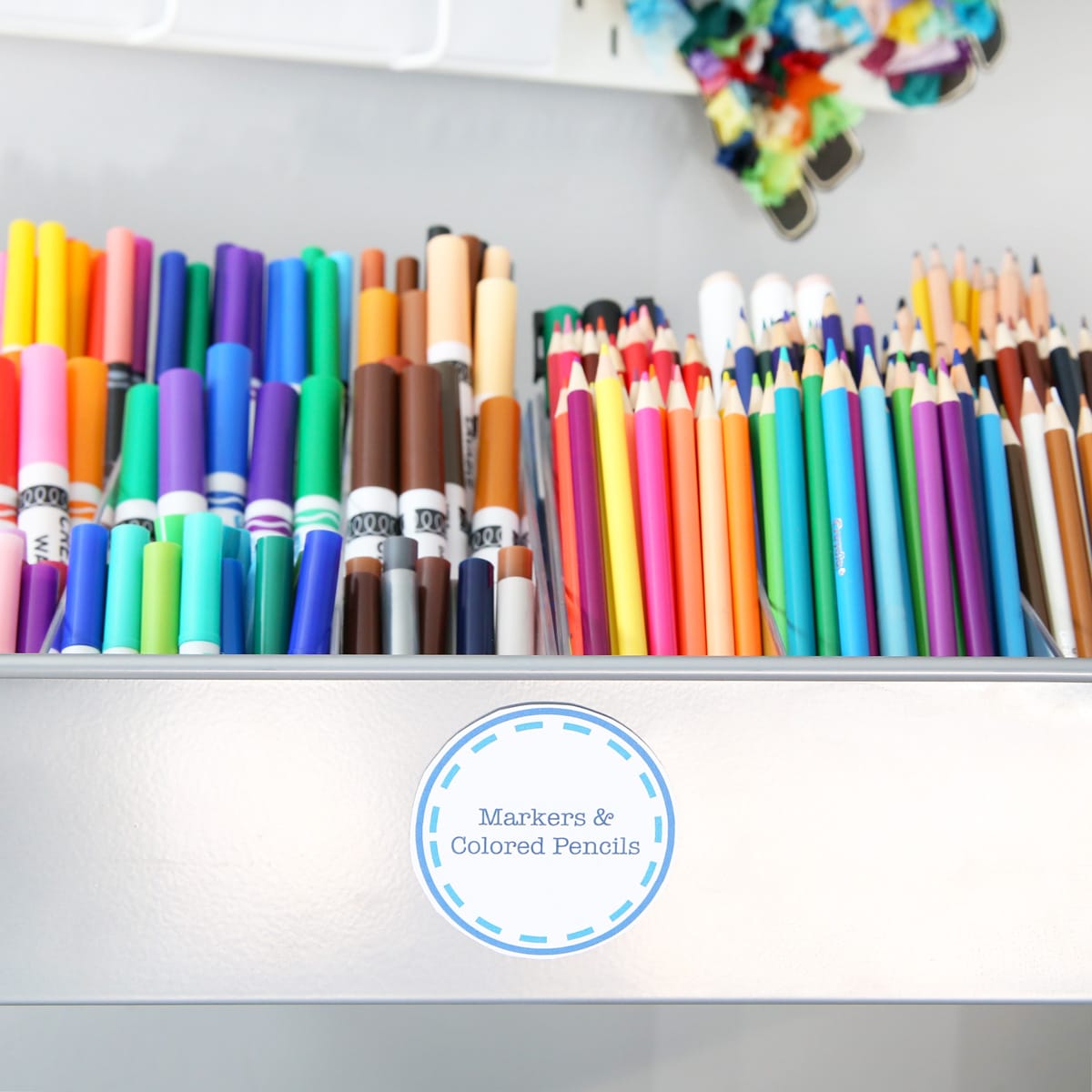 Rolling Cart with a Round Label Made in Microsoft Word that Says "Markers & Colored Pencils"