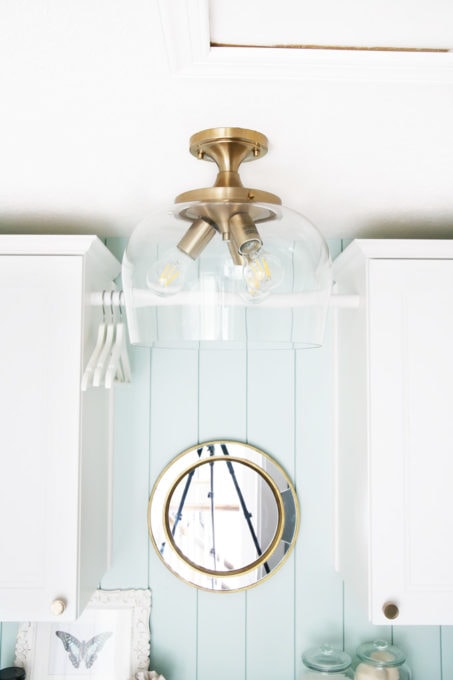 Beautiful Organized Laundry Room with a Semi-Flush Mount Light