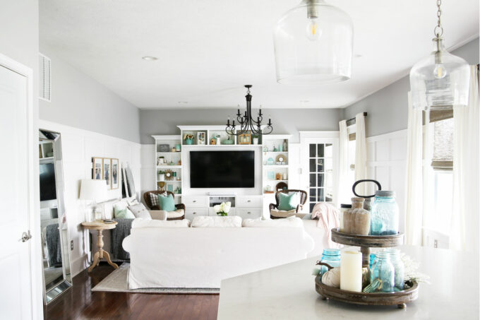 View of living room from kitchen in aqua, white, and neutrals as part of a whole house uniform to buy less decor