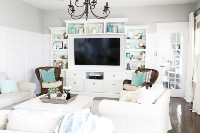 White Entertainment Center Made with IKEA BESTA Pieces in a Neutral Living Room with Aqua Accents