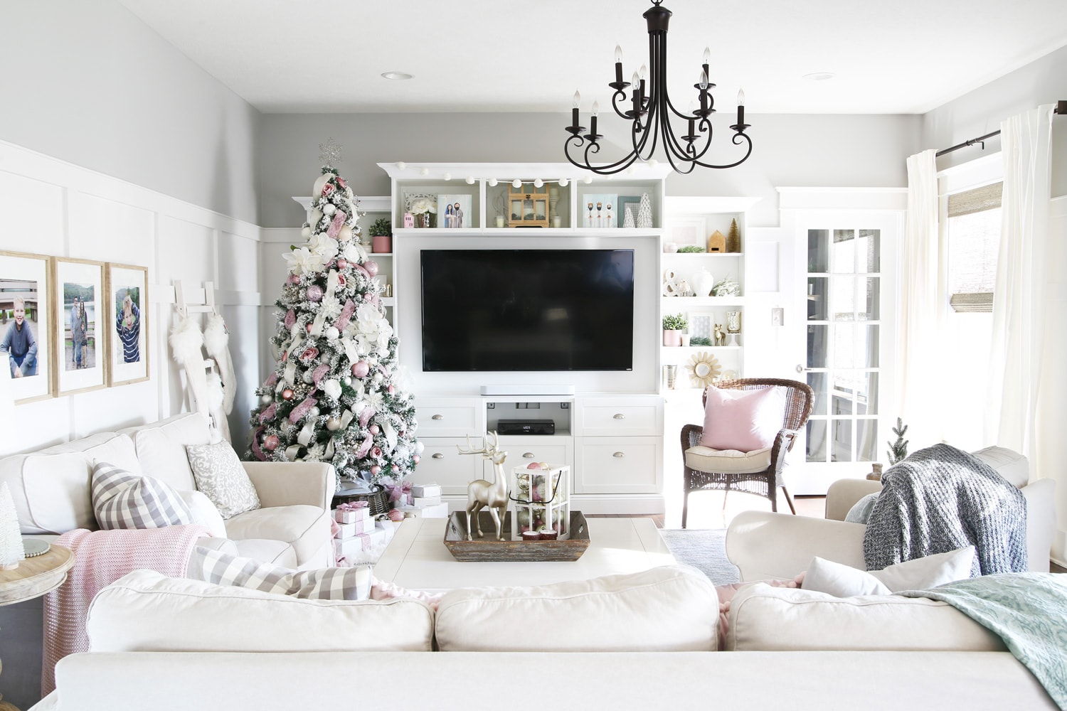 Living room with white entertainment center and pink Christmas decor