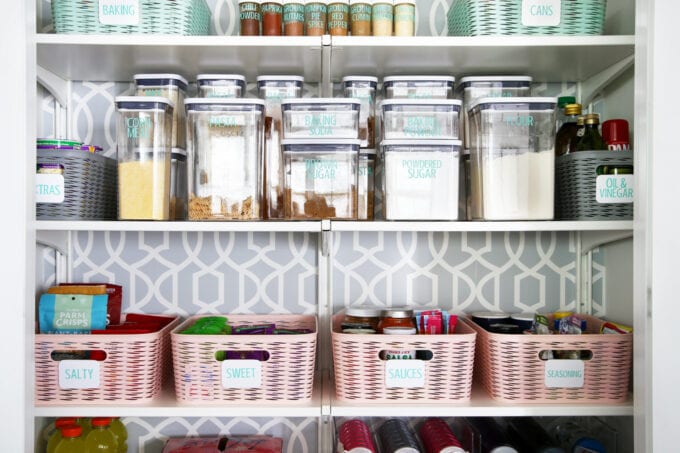 Organized pantry with decanted baking items, pasta, and spices